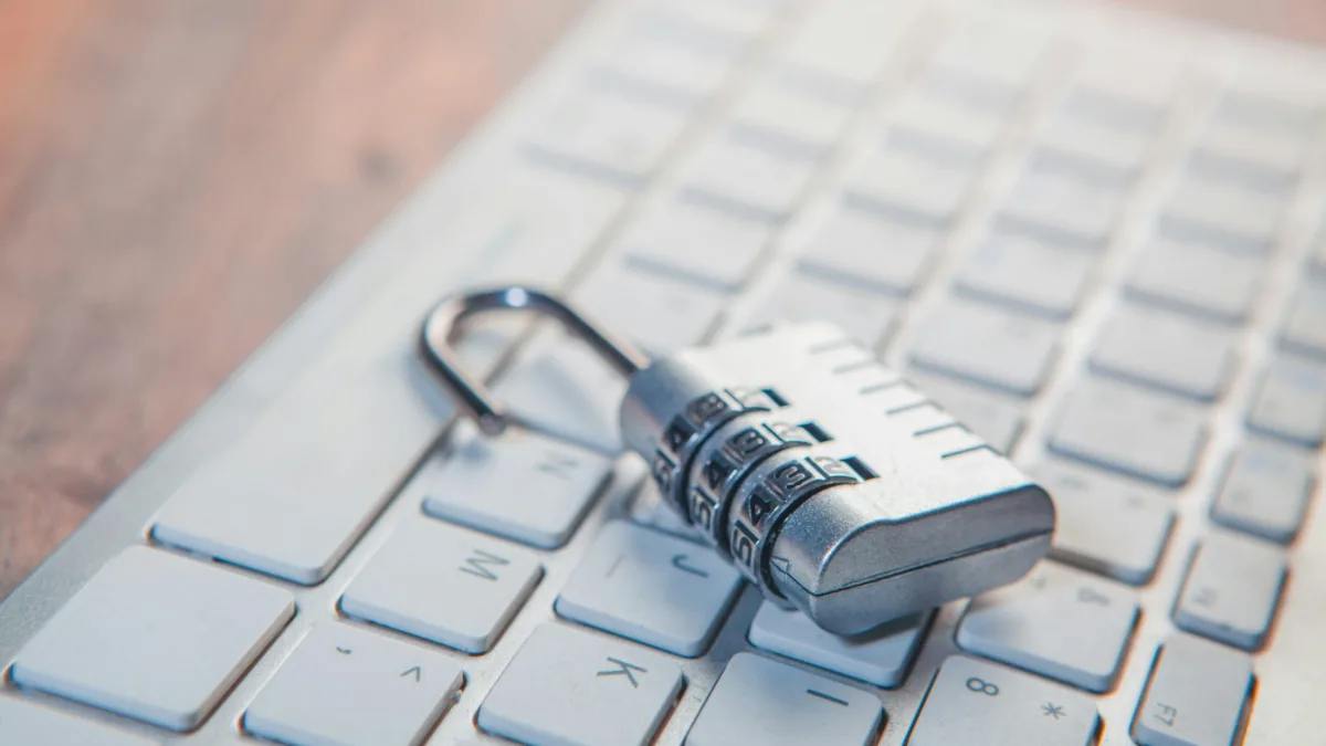 A combination lock rests on a computer keyboard.