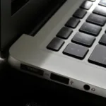 Free Detailed view of a silver laptop showing keyboard and multiple ports. Stock Photo