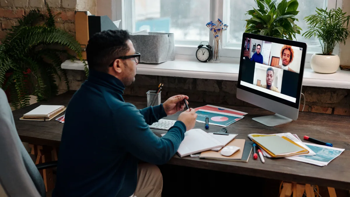 teacher-video-calling-with-his-students-using-a-computer
