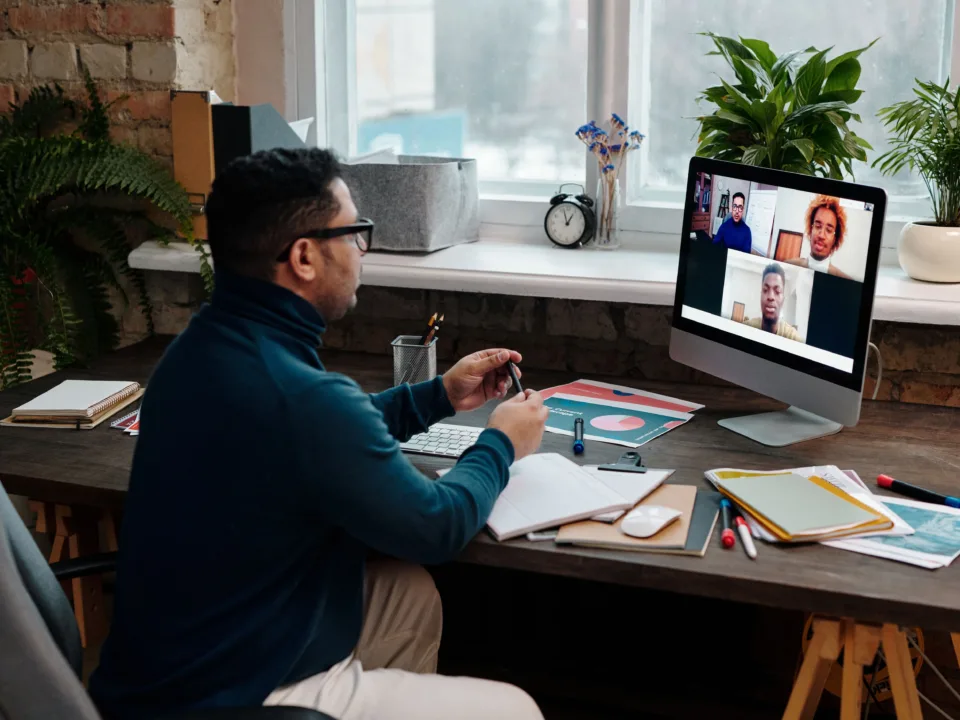 teacher-video-calling-with-his-students-using-a-computer